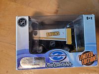 Front view of unopened Ertl Collectibles Boston Bruins Zamboni model box showing limited edition label and Bruins graphics on the model visible through window.