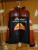 Front view showing design and branding of the jacket in brown, black, and tan.