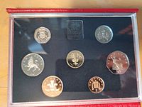 Top view of the proof coin set showing seven coins arranged around a central label with 'Elizabeth II 1985' text.