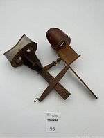 Two wooden stereoscope viewers side-by-side, showing size and structure with one having card holder and the other not.