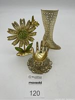 Photo showing the full set of three gold mid-century decorative jewelry holders: flower, hand, and boot shapes.