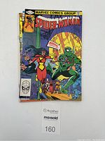 Photo showing the front cover of Spider-Woman Vol.1 No.45 comic book featuring Spider-Woman and a villain with green scaly costume.