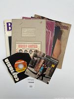 All items in the lot shown together including book, folder, sheet music, records, magazine.