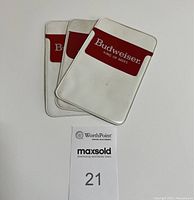 Three Budweiser branded vinyl pocket protectors stacked with logos visible.