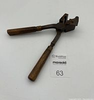Full view of Civil War era bullet mold showing wooden handles, metal mold portion, and hinge mechanism.