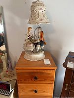 Lamp on top of five-drawer dresser, showing overall look and size comparison.