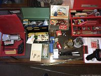 Various soldering tools, toolbox, and accessories on table