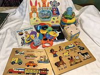 Overview of the baby items including puzzles, books, toys and stacking rings.