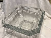 Clear heavy lead crystal bowl with hexagonal shape, shown from a top-down angle on white draped fabric background.