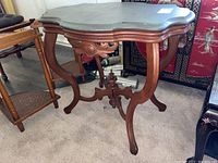 Photo of full console table showing overall shape, wood legs and painted top surface.