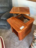 End table with the lifting top extended showing the pull-up arm mechanism and inner compartment.