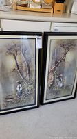 Two framed 3D art pieces displayed leaning against a wall, each approximately 15x25 inches with black frames.