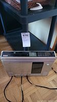 Front and top view of RCA vintage CD player showing the control panel and display with buttons and disc tray.