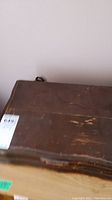 Wooden box with scratches on the exterior.