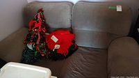 Side view of the gray microsuede loveseat sofa with some items on the seat.
