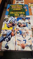 Front view of the NFL official collector's box showing several football players in action and label details.