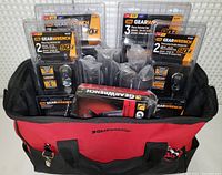 Front view of red/black GearWrench tool bag filled with packaged ratchet sets and tools