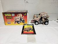 Spawn Violator Monster Rig vehicle, original box and comic book, and receipt laid out on white surface.