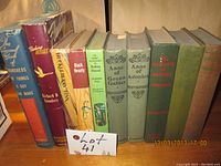 Front view of the 10 old books showing titles and condition, with varying cover colors and binding types.