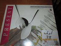 Box front showing 14-piece WMF Cromargan fish cutlery set with forks and knives illustration and label Present