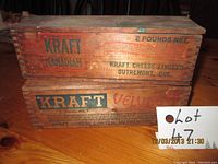 Stack of two vintage Kraft cheese boxes on wooden table, visible logo and text on box sides.