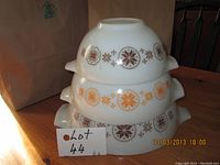 Stacked view of three Pyrex nesting bowls showing exterior pattern and size difference