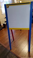 Front view of the white magnetic dry erase board side of the easel with visible Crayola logo on the top left corner.