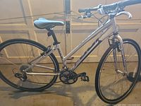 Full side view of silver Fuji Absolute 3.0 LE road bicycle with black saddle and aluminum wheels