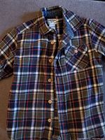 OshKosh plaid button down shirt in green, blue, and brown colors with buttons and chest pocket