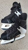 Pair of black and white boys ice hockey skates, size 4-5, showing front and side profile.