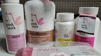 Pink Stork pregnancy support products including Mist Morning Sickness spray, Cocolaurin, Folate, and Pro Prenatal Probiotic bottles.