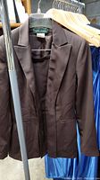 Brown women's blazer from Harv Bernard Collection hung on rack with notched lapels