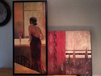 Both paintings leaning against a wall, showing overall lot