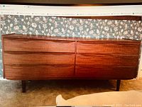 Full front view of dresser showing six drawers and tapered legs