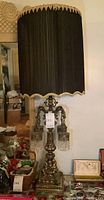 Full view of the lamp with black sheer fabric main shade showing gilded scalloped edges