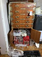 Full view of Asian chest showing four drawers and bottom cabinet open with items inside