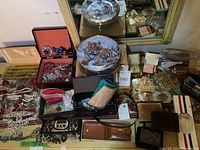 Overview of lot showing jewelry, boxes, wallets, eyeglasses and belt buckles