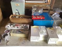 Overview of lot showing boxed crystal decor, Sorelle Christmas figurines, photo frames, and crystal bowl