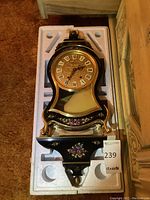 Lot contents in original foam packaging showing clock and shelf