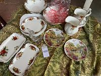 Overall view of figurine, china trays, bowls, pitchers, plates