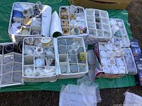 Overview photo showing many padded cases holding various fine china cups, saucers, crystal glasses and goblets neatly packed for transport.