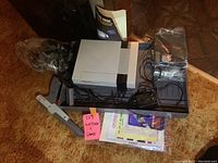 Overview of NES console, controllers, Zapper, games, literature, and carrying case