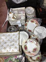 Overview of plates, cups, saucers, crystal bowls and quilted storage cases