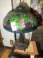 Full view of lamp showing stained glass shade and metal base