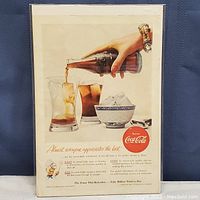 Front side showing the vintage Coca-Cola ad with a hand pouring Coke over ice into a glass.