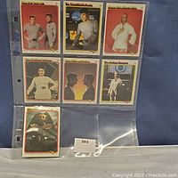 Photo of Star Trek collector cards in plastic sleeves, showing characters and scenes from the original series.
