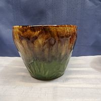 Full side view of the vintage pottery flower pot jardiniere showing brown-to-green drip glaze and textured surface