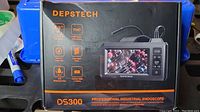 Front view of the Depstech DS300 Professional Industrial Endoscope box showing product features including 4.3 inch display, FHD video, built-in image tap, semi-rigid cable, IP67 waterproof probe, and lithium ion battery.