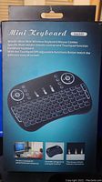 Front of the packaging showing the mini wireless keyboard and touchpad combo with product features and image.