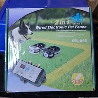 Front view of the boxed Okpet 2 in 1 Wired Electronic Pet Fence showing transmitter and two receiver collars.